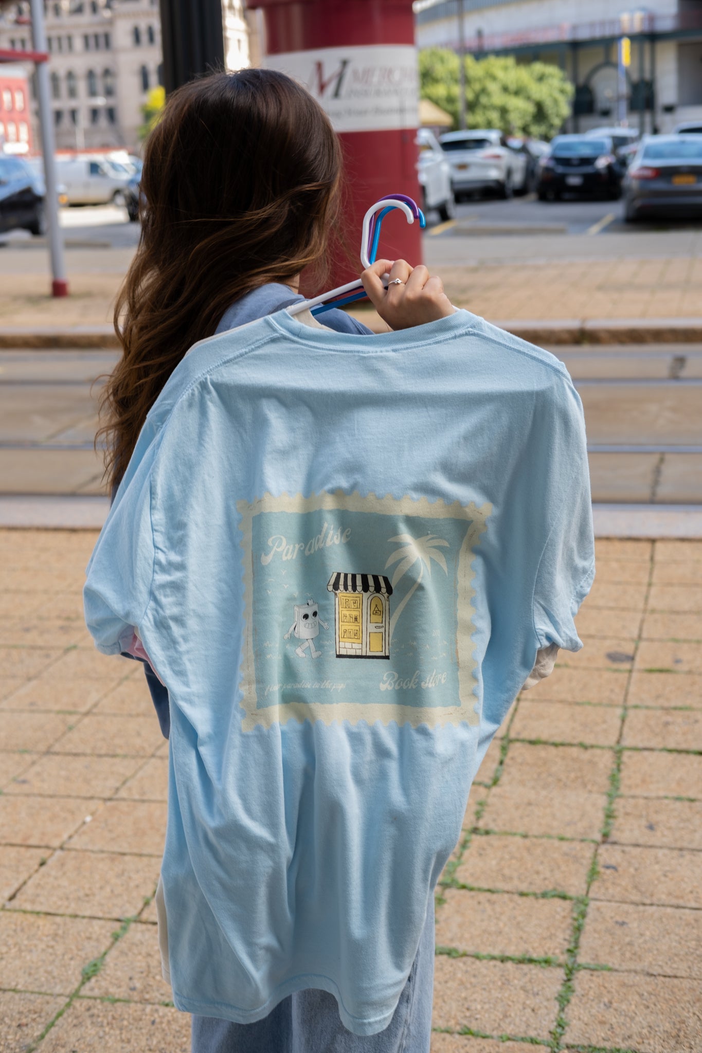 girl wearing a paradise book store aesthetic oversized tee from small business raye of happiness