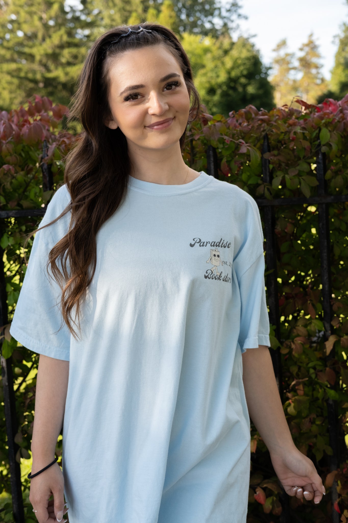 girl wearing a paradise book store aesthetic oversized tee from small business raye of happiness