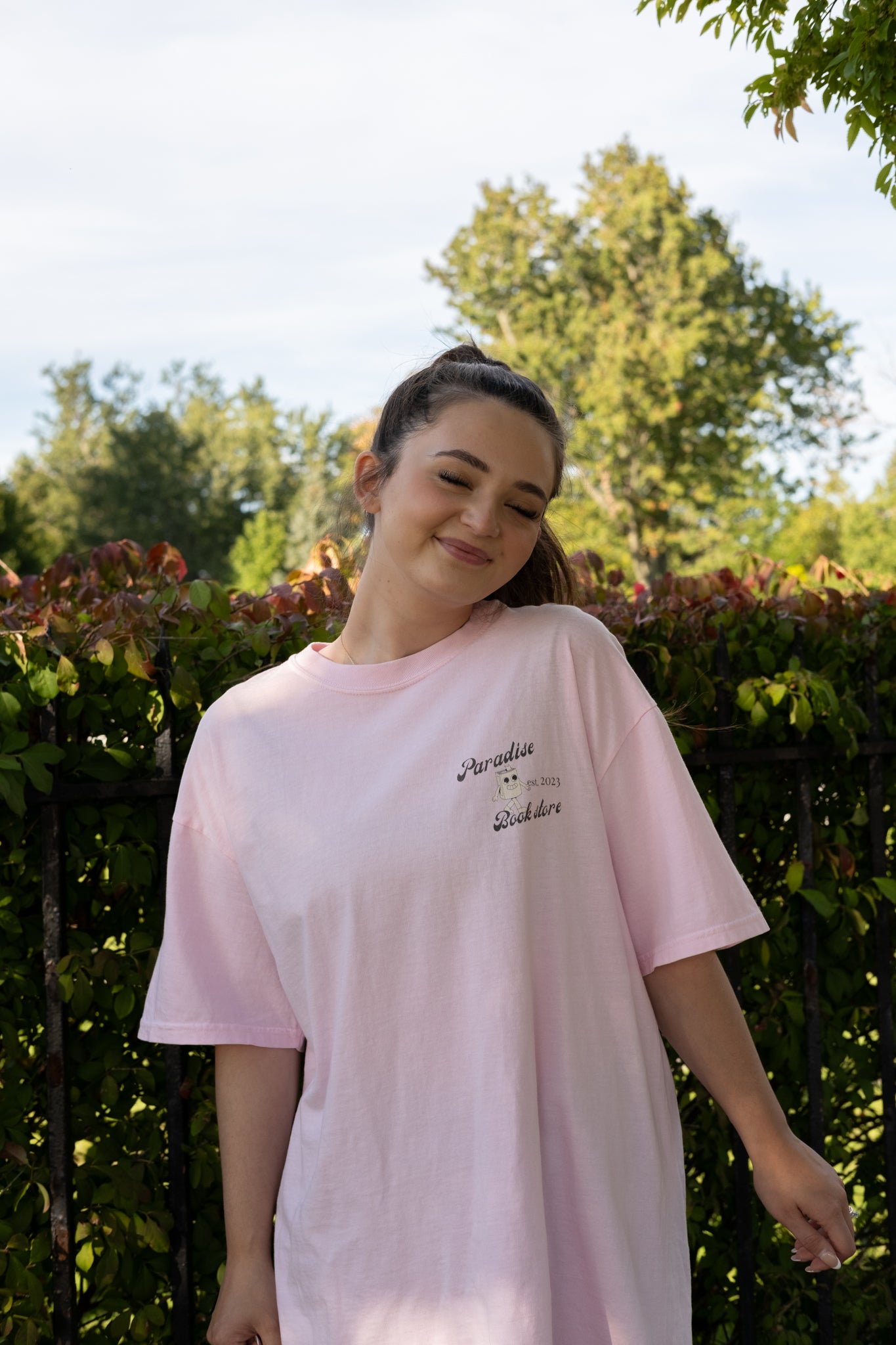 girl wearing a paradise book store aesthetic oversized tee from small business raye of happiness