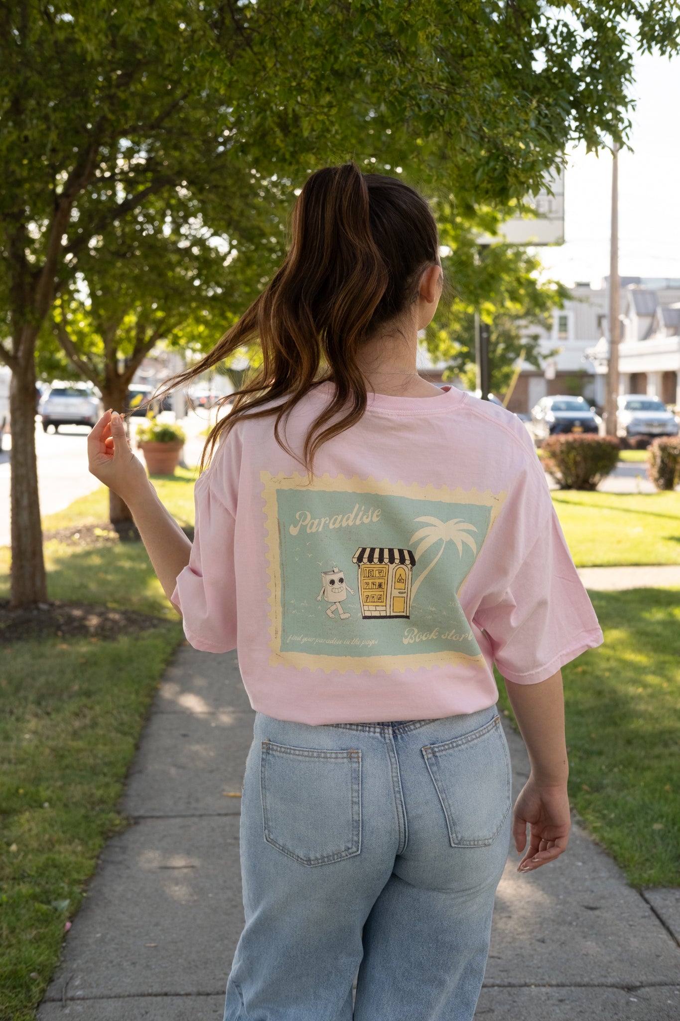 girl wearing a paradise book store aesthetic oversized tee from small business raye of happiness